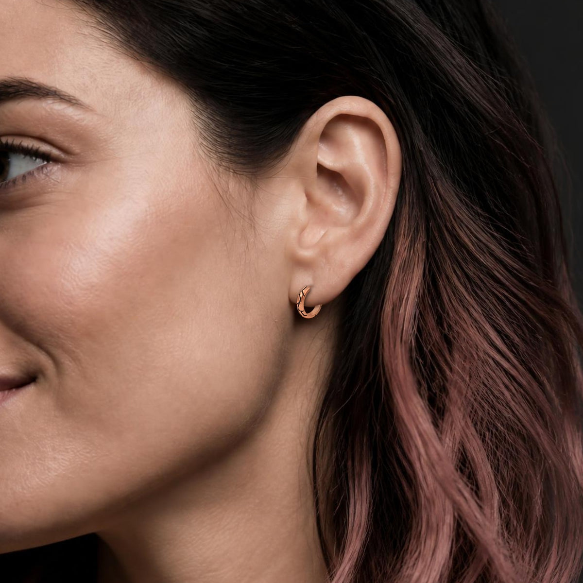 Kintsugi huggie earring in rose gold, worn, close-up on the ear