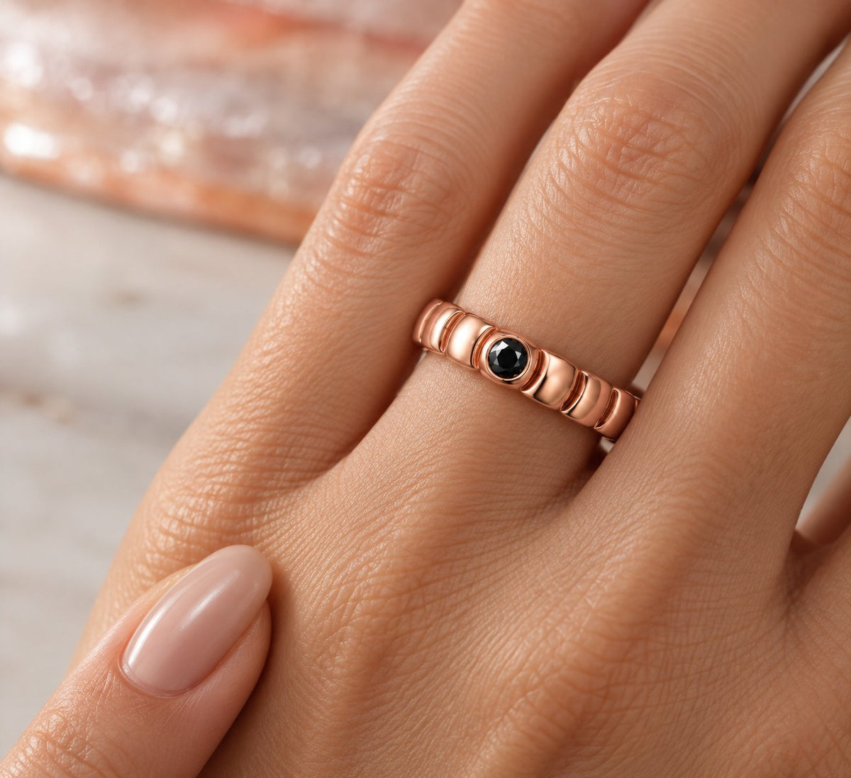 Gravitational Wave wedding band in rose gold, worn on the hand