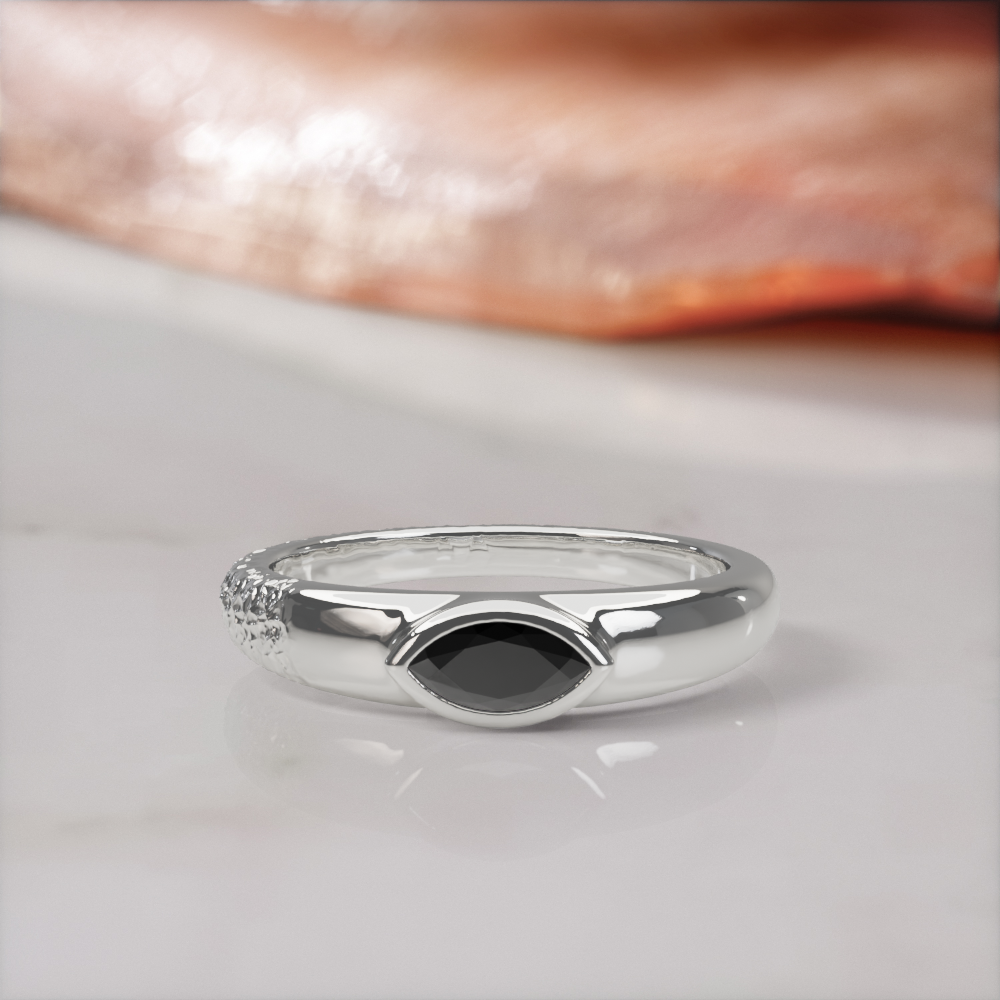 Disturbed engagement ring in white gold, front view of the marquise black diamond low in its polished bezel